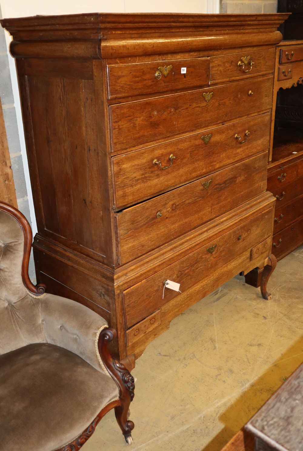 An early18th century oak chest on stand, with frieze drawer, two short and three graduated long drawers, over a further long and two sh